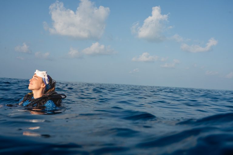 Woman swimming in the warm waters by the Conte Max